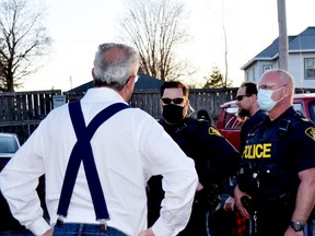 MPP Randy Hillier (left) confronts police at an anti-mask rally in Kemptville.