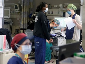 Nurses working within one of the units at the Queensway Carleton Hospital during the early stages of the pandemic last year.