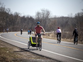 Files: Capital-area residents took advantage of the extra space to safely cycle on the Sir George-Étienne Cartier Parkway on April 10, 2021. The National Capital Commission closed part of that parkway as well as parts of the Sir John A. Macdonald Parkway and Queen Elizabeth Driveway to vehicle traffic for part of the day to allow for individual exercise.