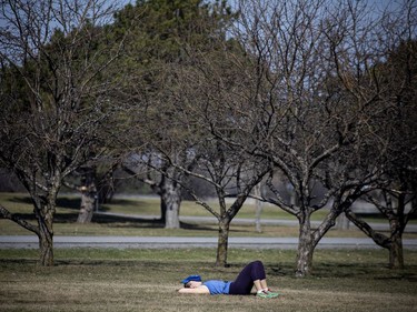 A woman has a little nap in the warm sun near the Aviation Museum in the city's east end on Saturday.