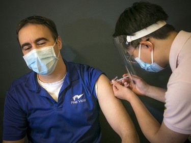 Benjamin Pateneude received his vaccine from University of Ottawa medical student Harry Wang on Saturday morning.