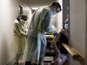 File: Healthcare workers from Humber River Hospital administer a second dose of the Pfizer COVID-19 vaccination at a seniors' residence in Toronto