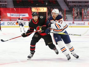 Connor Brown  of the Ottawa Senators battles against Connor McDavid #97 of the Edmonton Oilers in the second period at Canadian Tire Centre on April 7, 2021 in Ottawa, Ontario, Canada.