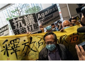 Former lawmaker and vice chairman of the Hong Kong Alliance in Support of Patriotic Democratic Movements in China Albert Ho leaves West Kowloon court after being given a suspended sentence on April 16, 2021 in Hong Kong. Seven prominent democratic figures, including Apple Daily founder Jimmy Lai, former lawmaker and barrister Martin Lee and Margaret Ng, were convicted of unauthorized assembly in relation to a peaceful protest on Aug. 18, 2019.