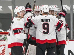 Goalie Matt Murray #30 of the Ottawa Senators is congratulated by teammates Drake Batherson #19, Josh Norris #9 and Artem Zub #2 after defeating the Vancouver Canucks 3-0 in NHL action at Rogers Arena on April 22, 2021