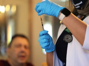 FILE: A doctor prepares a dose of the Johnson & Johnson vaccine.