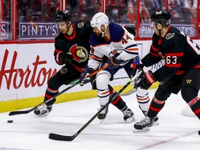 Ottawa Senators defenceman Artem Zub (2) and right wing Evgenii Dadonov (63) check Edmonton Oilers right wing Zack Kassian (44) during second period NHL action at the Canadian Tire Centre.
