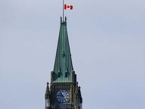 The Canadian flag flies at half staff on the Peace Tower.