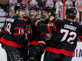 Ottawa Senators center Josh Norris (9) is congratulated on his goal against the Vancouver Canucks by teammates during first period NHL action at the Canadian Tire Centre.