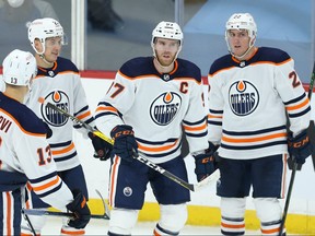 Edmonton Oilers centre Connor McDavid (second from right) sort of celebrates his third goal of the game against the Winnipeg Jets on Monday.