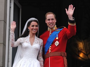 Prince William and his wife Catherine, Duchess of Cambridge, wave to the crowd from the balcony of Buckingham Palace in London on April 29, 2011, following their wedding.