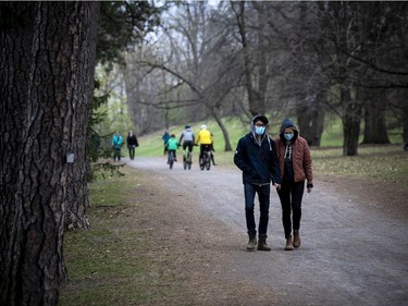 The on and off rain showers did not stop people from heading out to stroll through the Arboretum, part of the Central Experimental Farm, Sunday, April 25, 2021, to enjoy the blossoms on the apple trees and the magnolias.