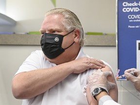 Ontario Premier Doug Ford receives the Oxford-Astrazeneca-COVID-19 vaccine from pharmacist Anmol Soor in Etobicoke Friday.