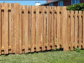 Fence-All’s crews can cover metal fence posts with wood facing so the resulting fence looks perfectly seamless.