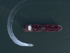 An aerial view shows a speedboat of Iran's Revolutionary Guard moving around the British-flagged oil tanker Stena Impero which was seized in the Strait of Hormuz on Friday by the Guard, in the Iranian port of Bandar Abbas in 2019. Iran and the West has been at odds for years, but the revival of the nuclear deal could cool tensions.
