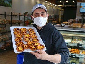 Owner Andre Esteves of Lusa Bakery, 1111 Wellington St. W. in Hintonburg, holds a tray of Portuguese Custard Tarts.


ORG XMIT: 135441