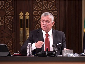 (FILES) In this file handout picture released by the Jordanian Royal Palace on March 23, 2021, Jordanian King Abdullah II speaks during a meeting at the House of Representatives in the capital Amman. - Jordan's King Abdullah broke his silence on April 7, 2021 to tell his nation that the worst political crisis in decades sparked by an alleged plot involving his half-brother Prince Hamzah was over.
