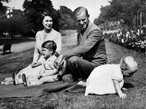 In this file photo from the 1950s, Queen Elizabeth II and Philip, Duke of Edinburgh, relax with their two oldest children, Charles, Prince of Wales (L) and Princess Anne (R).