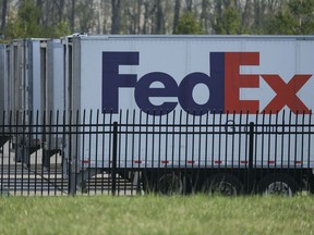 FedEx trailers are parked at the site of a mass shooting at a FedEx facility in Indianapolis, Indiana, on Friday.