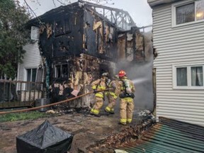 Ottawa Fire Services crews at the scene of a two-alarm fire on Autumn Hill Crescent in Blackburn Hamlet on Thursday.