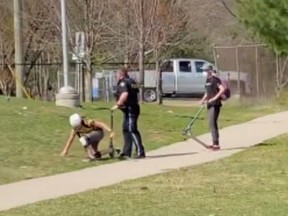 In this screenshot from a video posted to Instagram, a young boy can be seen getting up during a physical confrontation with an OPP officer.
