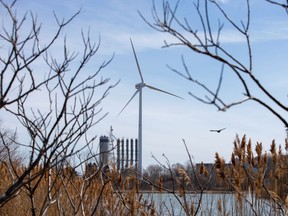 A wind turbine is seen near the Pickering Nuclear Power Generating Station east of Toronto. As Canada reduces its fossil fuel usage, we will need to take care of those whose jobs are disrupted by the move.