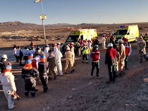 People and emergecy vehicles are seen after a large blast at a plant run by Enaexthe in the northern Chilean mining city of Calama, in this still image from a social media video April 16, 2021.