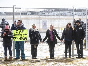 Supporters gather outside GraceLife Church near Edmonton, Alta., on Sunday, April 11, 2021 to protest not being able to attend in-church services. The church was fenced off by police and Alberta Health Services in violation of COVID-19 rules.