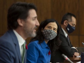 Files: Canada's Chief Public Health Officer Theresa Tam and Deputy Chief Public Health Officer Howard Njoo wear masks as they listen to Prime Minister Justin Trudeau speak during a news conference in Ottawa,  Friday, November 6, 2020.