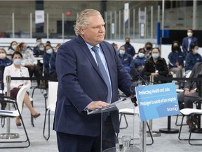 Premier Doug Ford listens to a question in late March as he announced only partial measures to deal with the surge of infection. This week, he finally issued a fuller stay-at-home order.