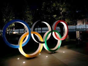 The Olympic rings are illuminated in front of the National Stadium in Tokyo, Japan January 22, 2021.