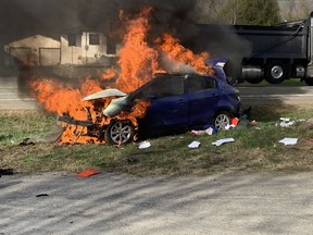 Firefighters extinguished a car fire after a vehicle rollover on Bank Street near Sale Barn road Tuesday morning.