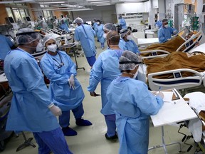 FILE PHOTO: Medical workers take care of patients in the emergency room of the Nossa Senhora da Conceicao hospital that is overcrowding because of the coronavirus outbreak, in Porto Alegre, Brazil.