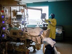 A nurse performs a wellness check of a coronavirus disease (COVID-19) patient inside the intensive care unit of Humber River Hospital in Toronto.