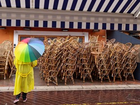 Files: A woman holding a rainbow umbrella