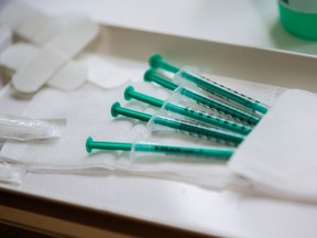 FILE: Prepared syringes with Pfizer-BioNTech coronavirus disease (COVID-19) vaccine.