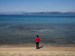 Rowena Harding, 46, stands on a beach following an interview with Reuters, amid the coronavirus disease (COVID-19) pandemic, on the island of Aegina, Greece, March 26, 2021.