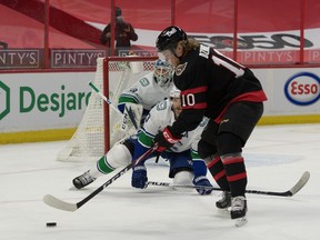 Ottawa Senators left wing Ryan Dzingel skates with the puck in front of defenceman Alexander Edler at the Canadian Tire Centre.