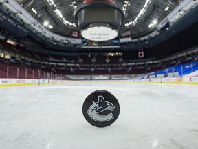 A view of a puck after the game between the Calgary Flames and Canucks scheduled for March 31, 2021, in Vancouver was postponed because of COVID-19.