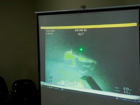 The military personnel display a video showing what is believed to be the sunken Indonesian Navy KRI Nanggala-402 submarine during a media conference at I Gusti Ngurah Rai Airport in Bali, Indonesia, April 25, 2021.