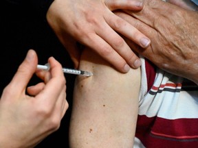 A man receives a dose of the Pfizer/BioNTech Covid-19 vaccine.