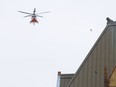 An Ornge emergency transport helicopter flies through the downtown Toronto core.