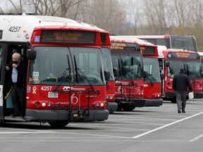 OC Transpo buses and riders at Hurdman Station in Ottawa.