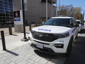 Ottawa Police Service cruisers parked beside the headquarters at 474 Elgin St.