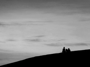 OTTAWA - April 29, 2021 -  Two people sit on a hill at sunset near Mooney's Bay Beach in Ottawa Thursday. TONY CALDWELL, Postmedia.