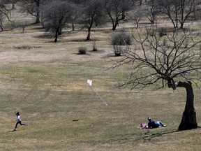 OTTAWA - April 5, 2021 -  A girl flies her kite during a family picnic at the Arboretum in Ottawa Monday.