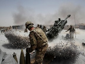 FILE PHOTO: U.S. Army soldiers from the 2nd Platoon, B battery 2-8 field artillery, fire a howitzer artillery piece at Seprwan Ghar forward fire base in Panjwai district, Kandahar province southern Afghanistan, June 12, 2011.