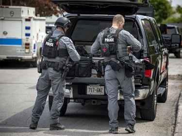 Ottawa police tactical members loaded the armoured vehicle with firearms and protective gear before driving into the area of the incident.