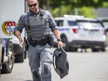 Ottawa police tactical members loaded the armoured vehicle with firearms and protective gear before driving into the area of the incident.