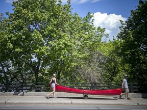 OTTAWA - Murray Richardson and his daughter Lauren Richardson walked their canoe down Sussex Drive Sunday, May 16, 2021. ASHLEY FRASER, POSTMEDIA